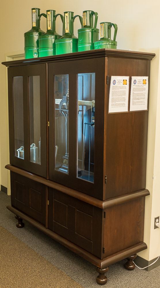 Scale weights sitting on a cabinet containing a scale