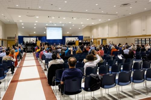 A group of people watching a presentation